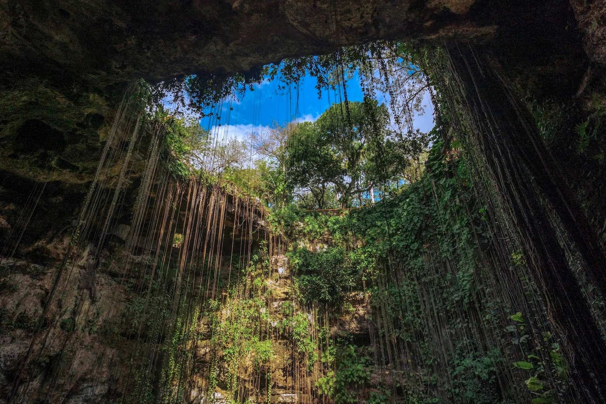 Chichen Itza pyramid El Castillo under blue sky on the Cancun minibus day trip